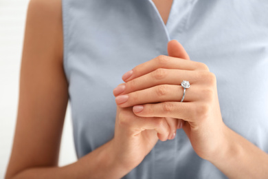 Photo of Young woman wearing beautiful engagement ring, closeup