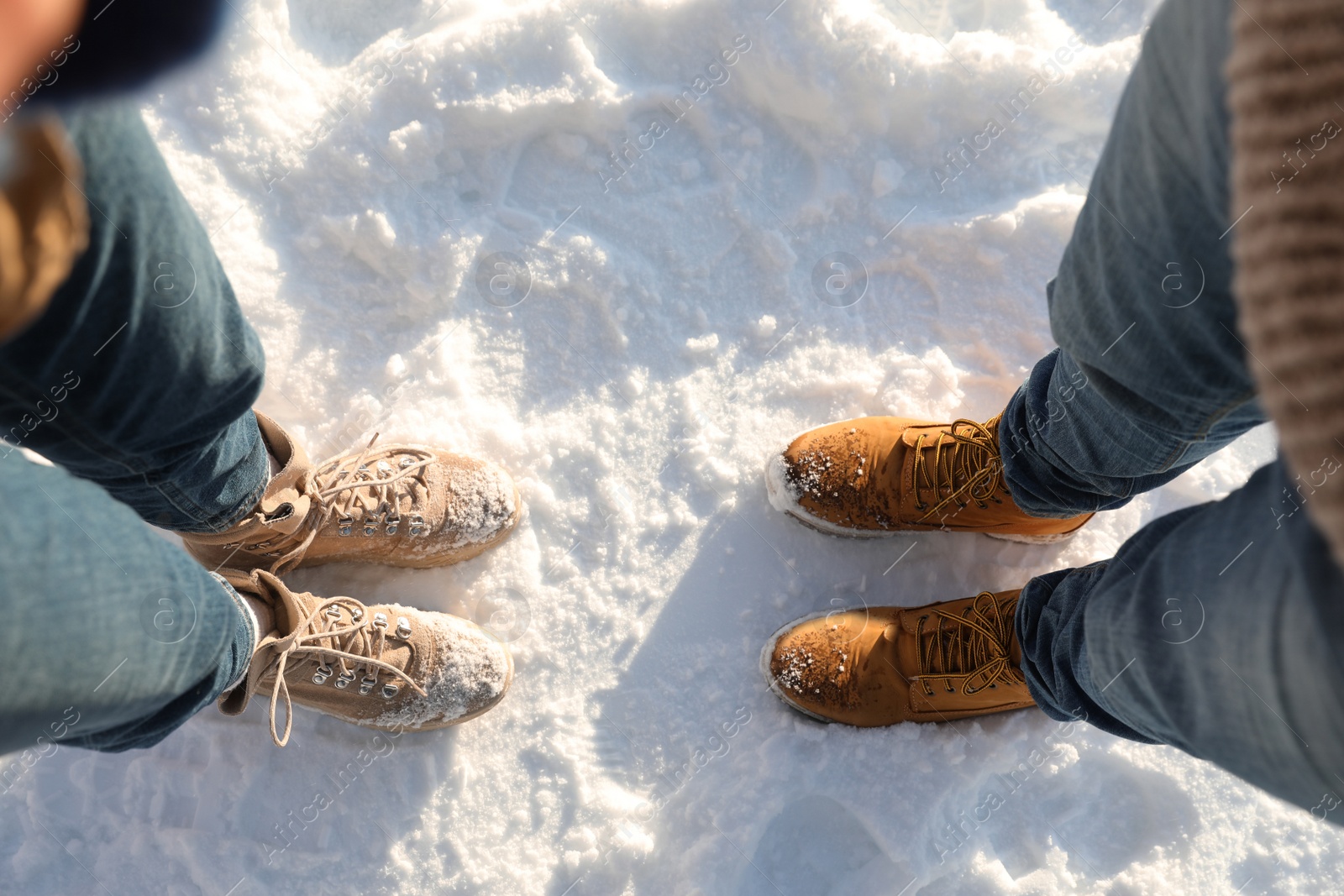 Photo of Couple standing on white snow, above view