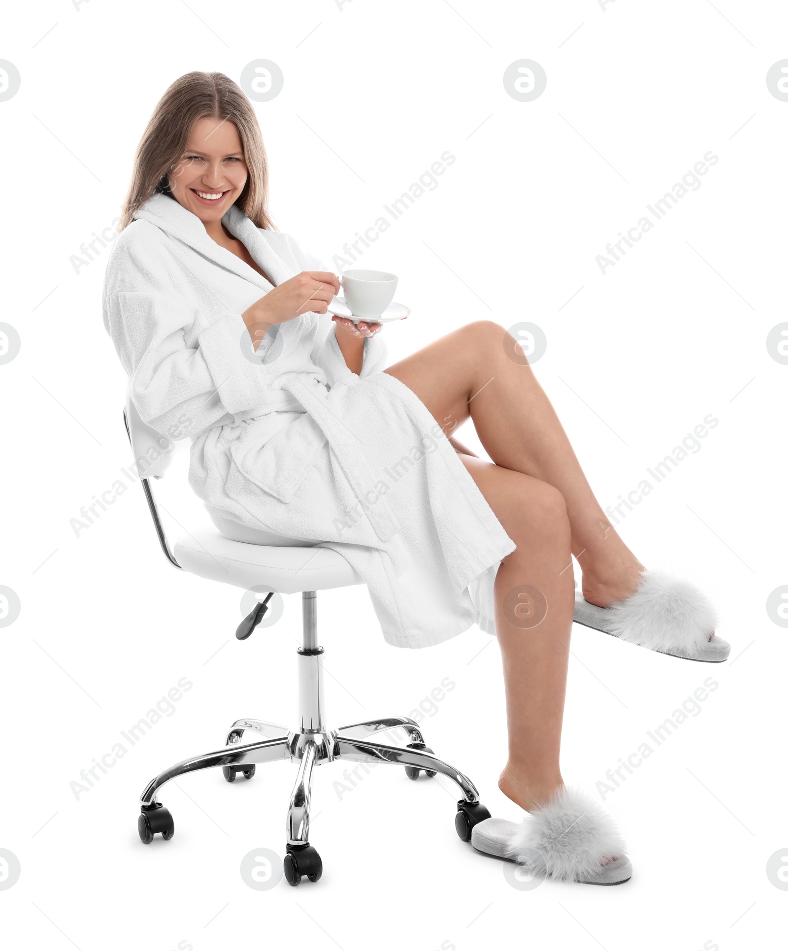 Photo of Young woman in bathrobe with cup of beverage on white background