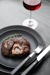Photo of Tasty grilled beef meat served on black table, closeup