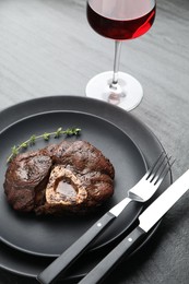 Tasty grilled beef meat served on black table, closeup