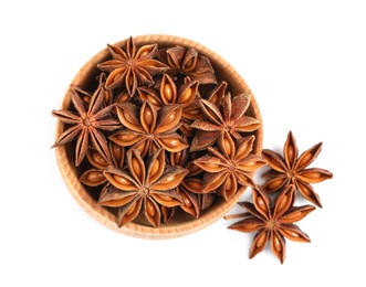 Photo of Wooden bowl and dry anise stars on white background, top view