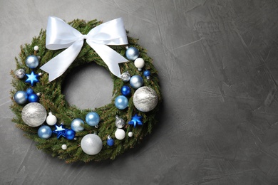 Beautiful Christmas wreath on grey background, top view. Space for text