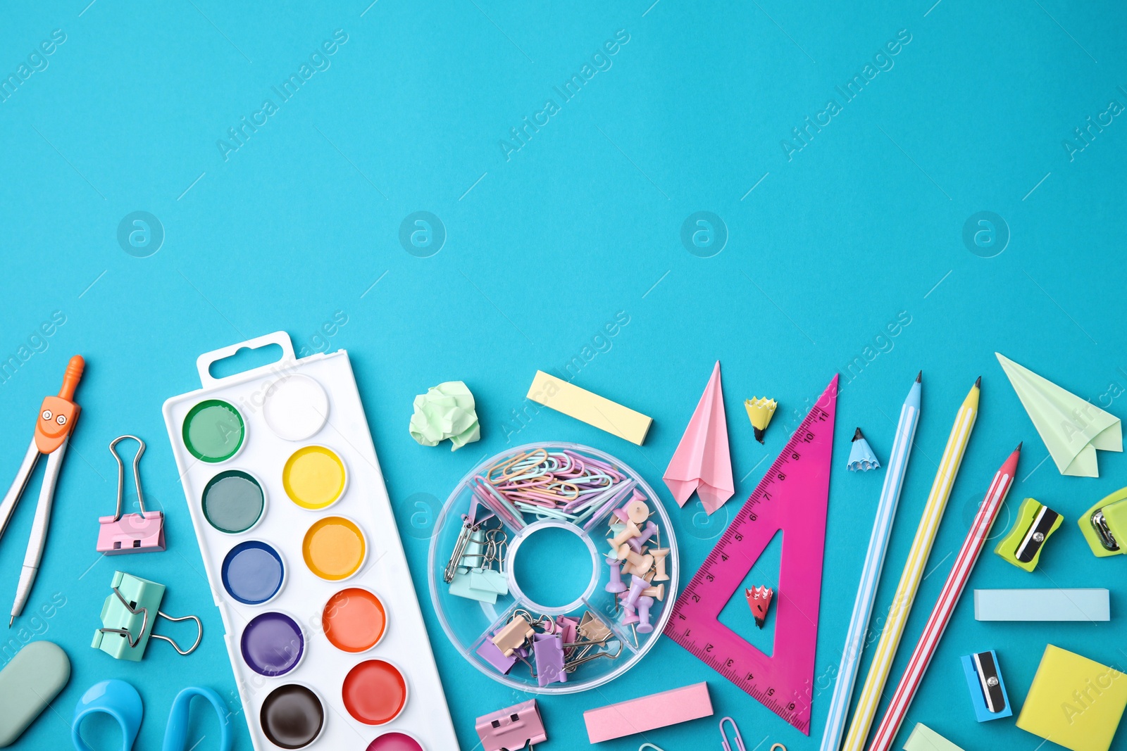 Photo of Different school stationery items on light blue background, flat lay with space for text. Back to school