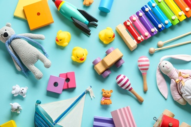 Photo of Flat lay composition with different toys on light blue background