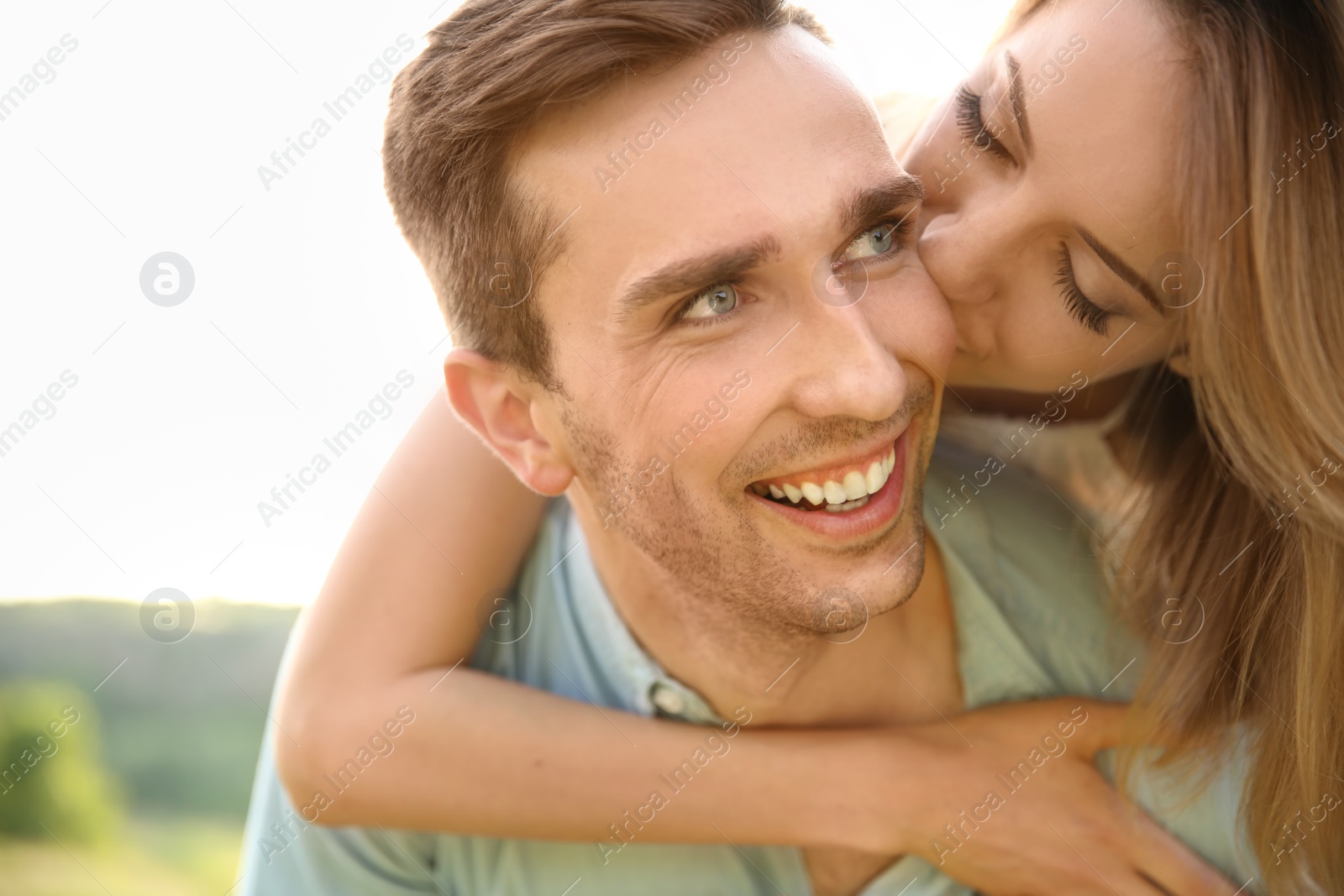 Photo of Cute young couple in love posing outdoors on sunny day