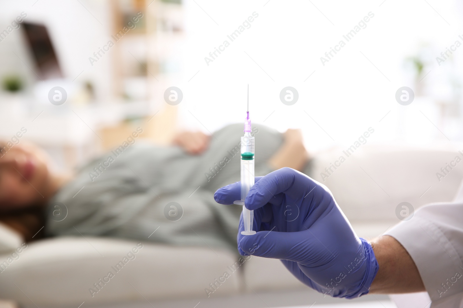 Photo of Doctor with syringe near pregnant woman in hospital, closeup. Vaccination concept