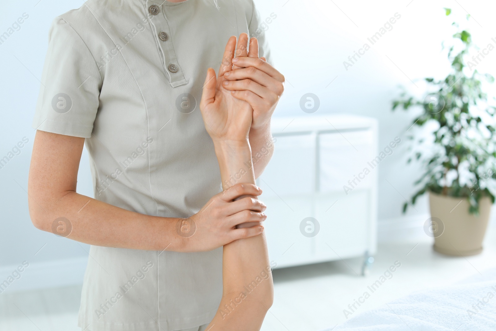 Photo of Woman receiving hand massage in wellness center