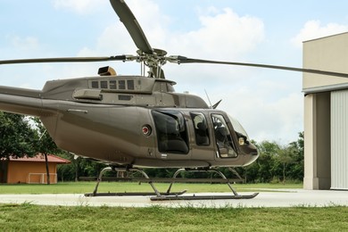 Photo of Beautiful helicopter on helipad near white hangar