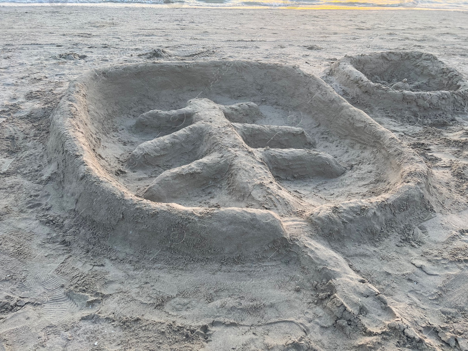 Photo of Palm tree made of sand on beach