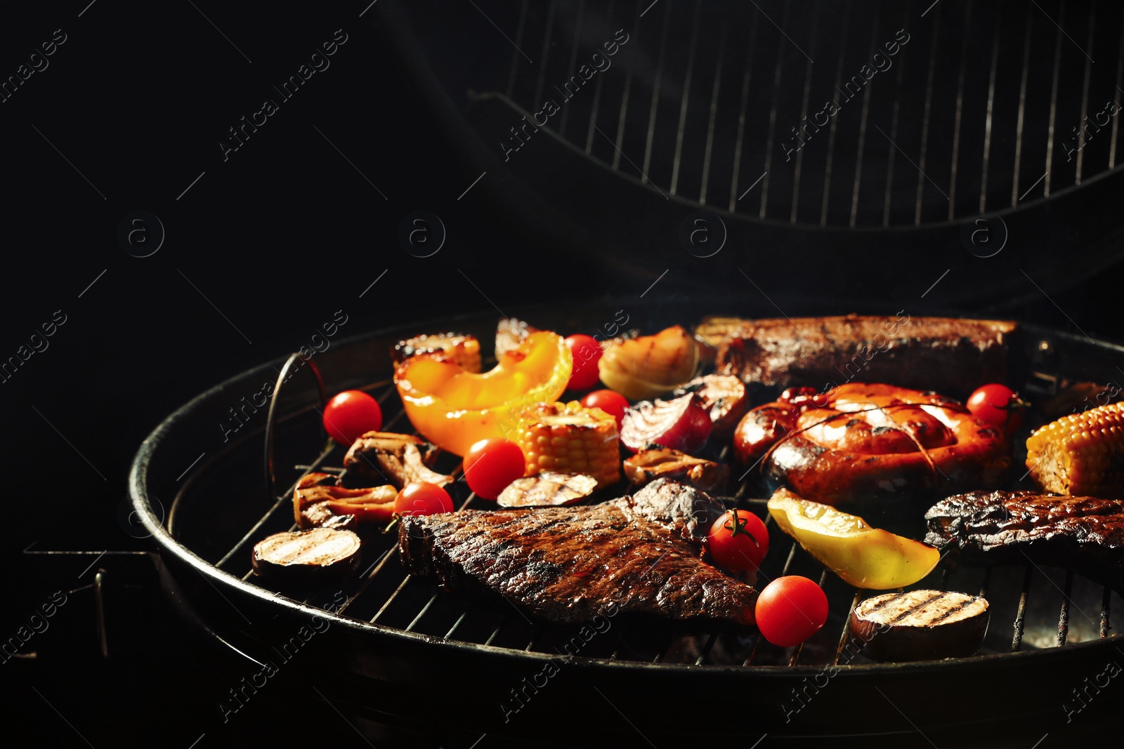 Photo of Assorted delicious meat and vegetables on barbecue grill