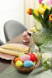 Photo of Easter celebration. Festive table setting with painted eggs.