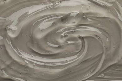 Clear cosmetic gel on grey background, top view