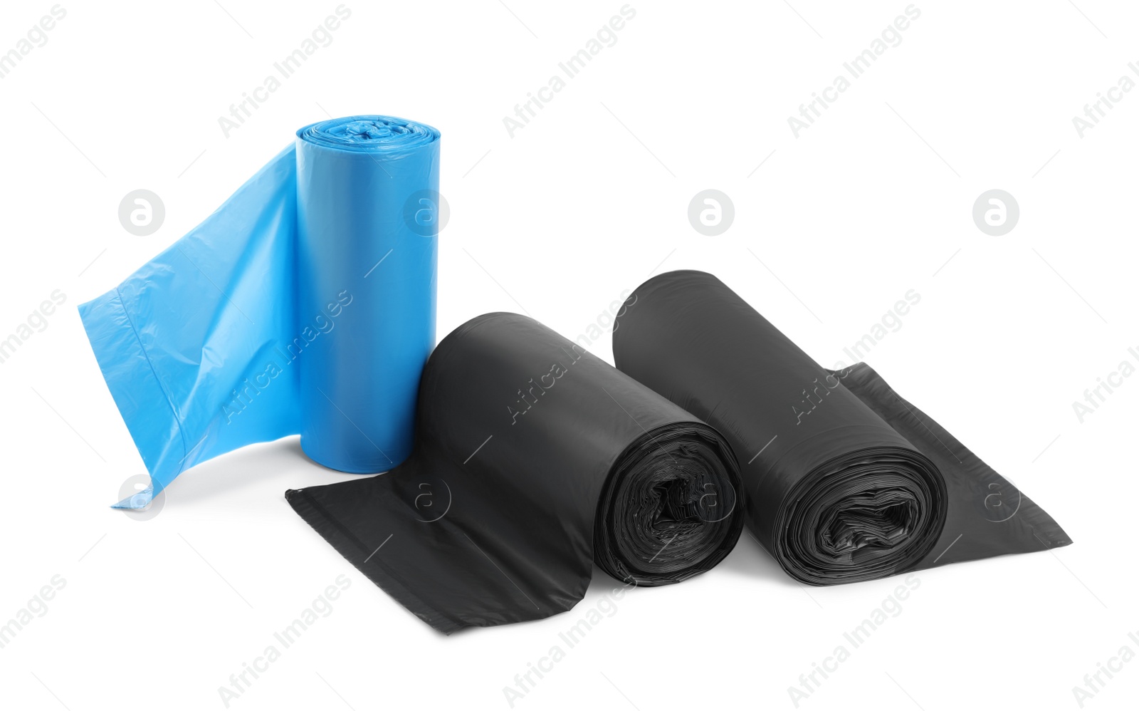 Photo of Rolls of different garbage bags on white background. Cleaning supplies