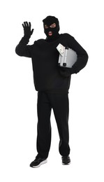 Emotional thief in balaclava with briefcase of money raising hand on white background