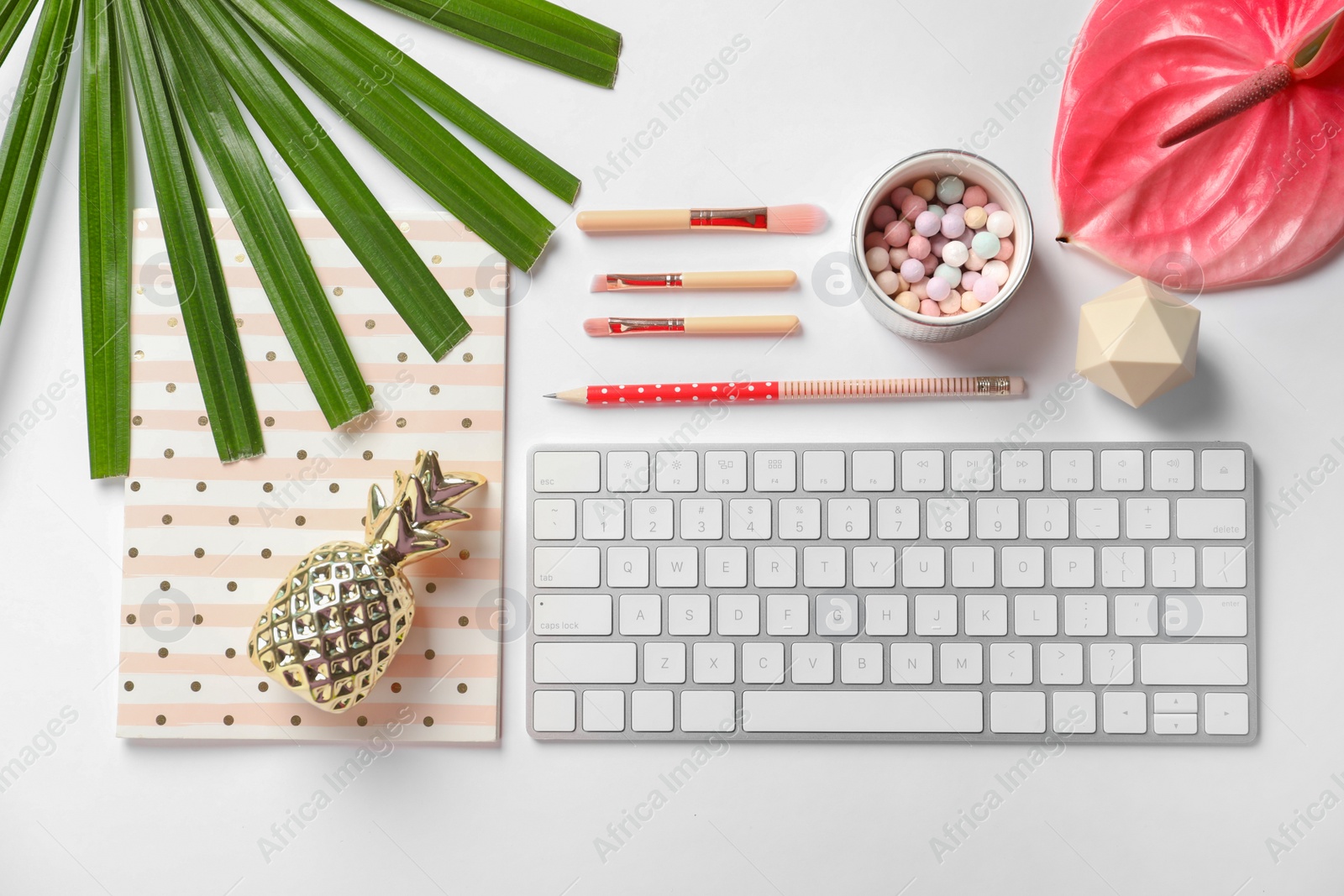 Photo of Creative flat lay composition with tropical flower, stationery and computer keyboard on white background