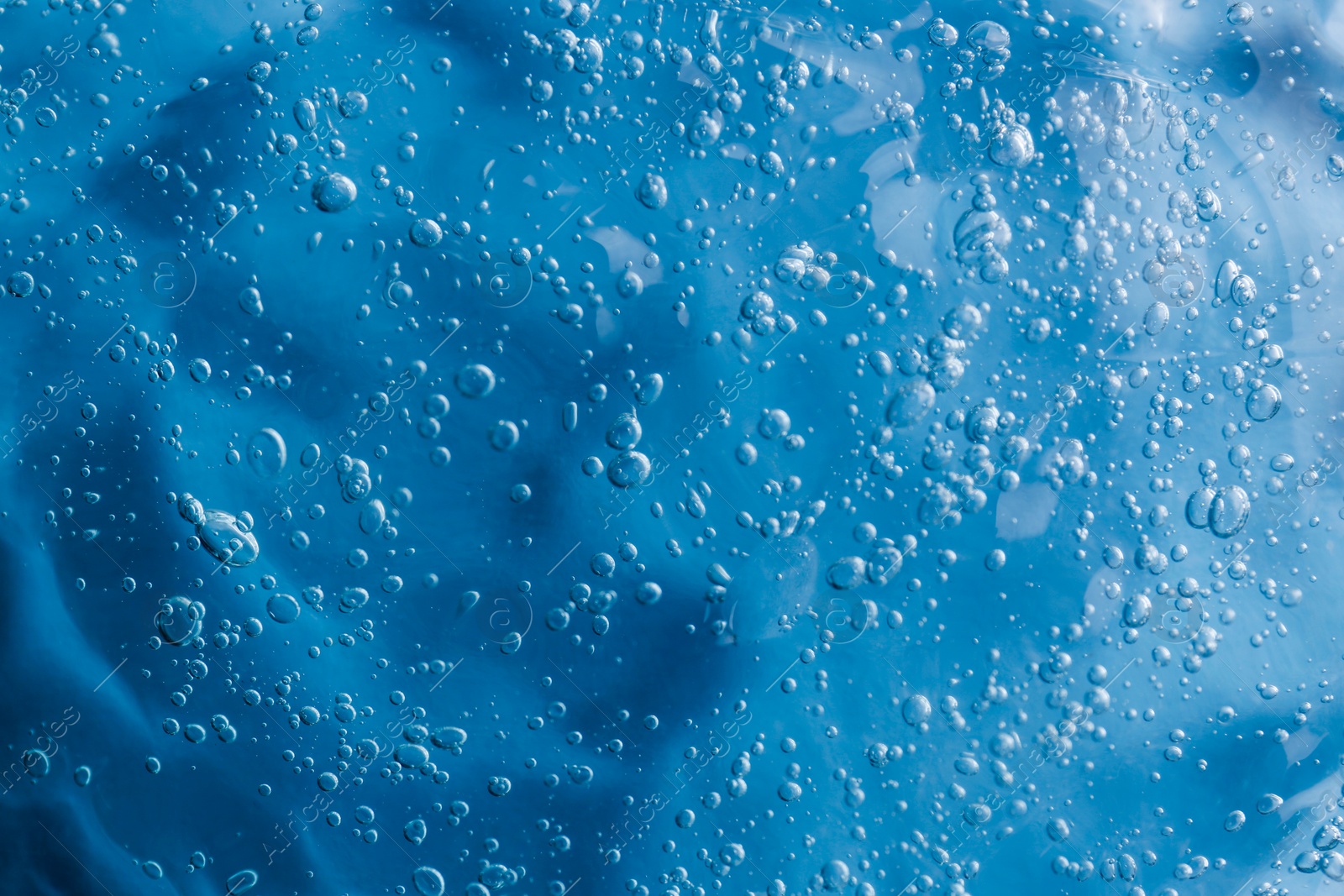 Photo of Texture of light blue shower gel as background, top view