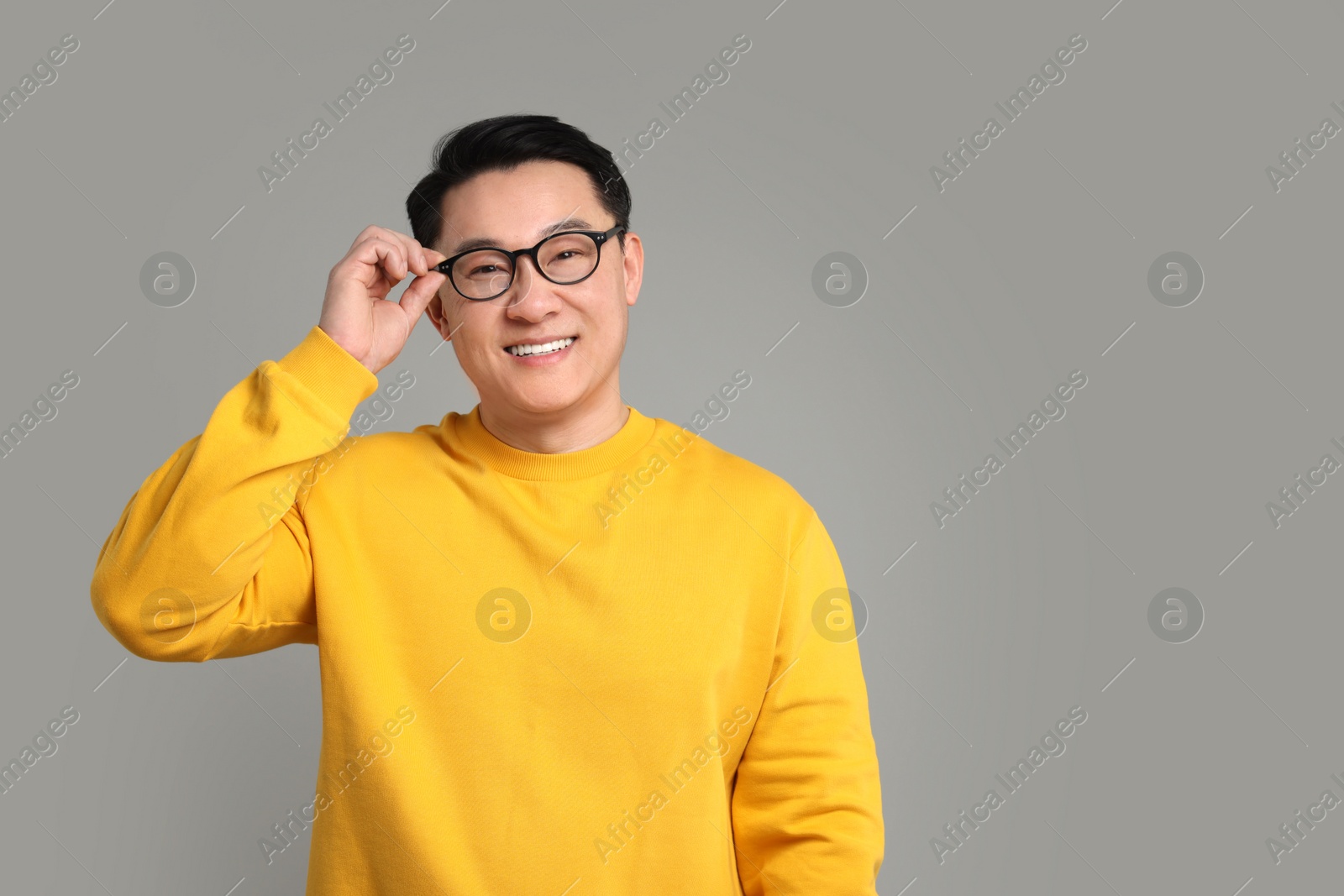 Photo of Portrait of happy man on grey background. Space for text