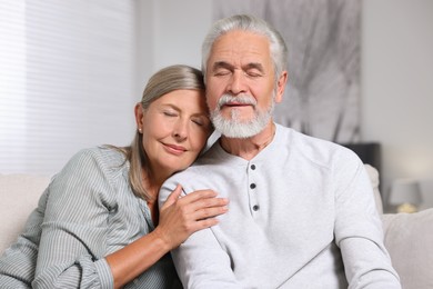 Photo of Portrait of affectionate senior couple at home