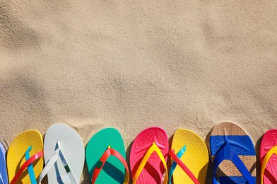 Stylish flip flops on beach, flat lay. Space for text