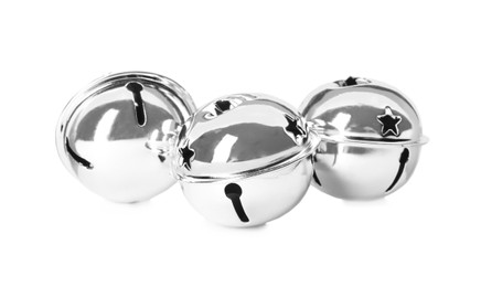 Photo of Shiny silver sleigh bells on white background
