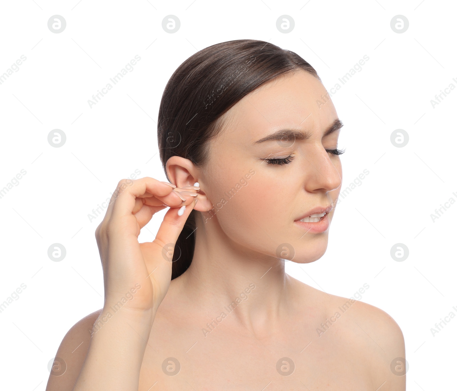 Photo of Young woman cleaning ear with cotton swab on white background