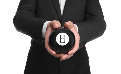 Man holding magic eight ball on white background, closeup