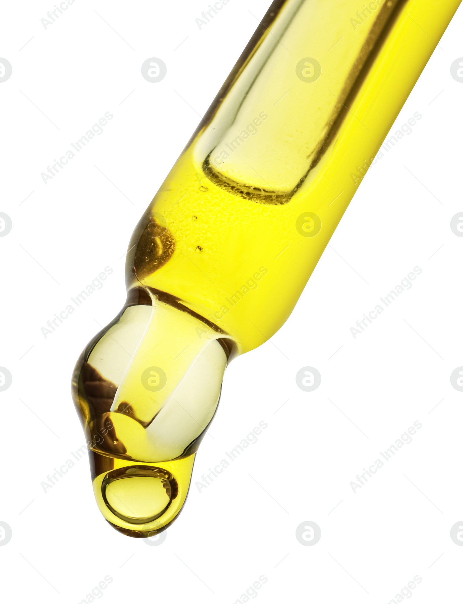 Photo of Dripping yellow facial serum from pipette on white background, closeup