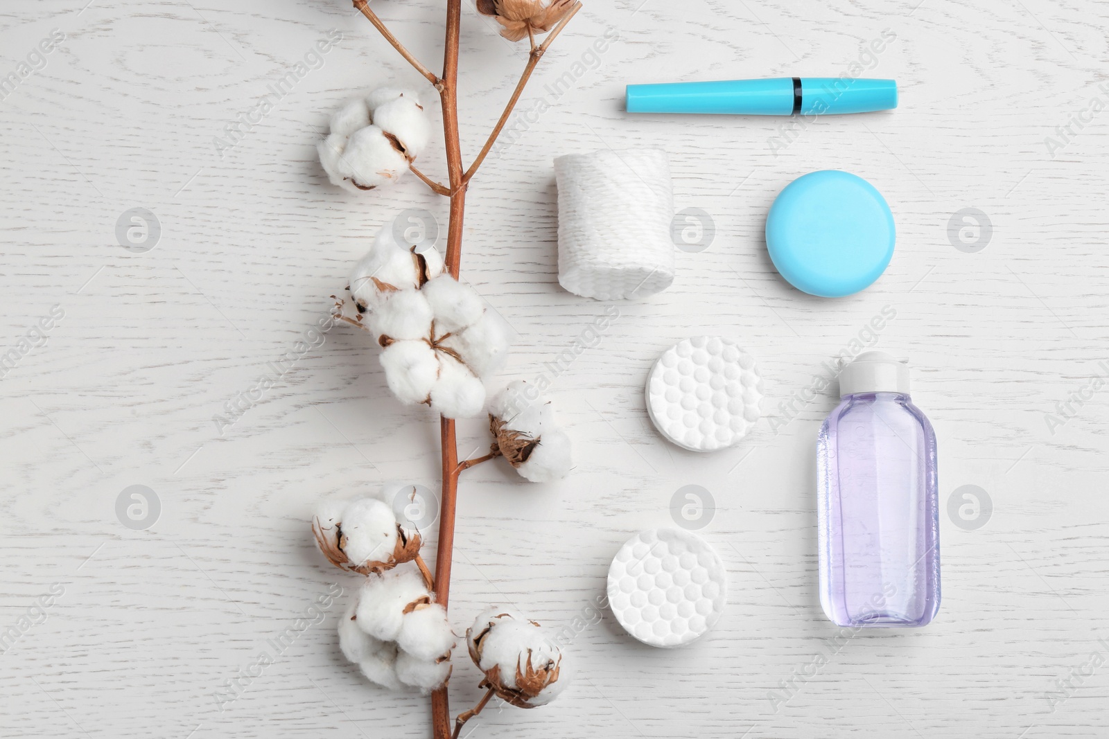 Photo of Flat lay composition with cotton pads on white wooden background