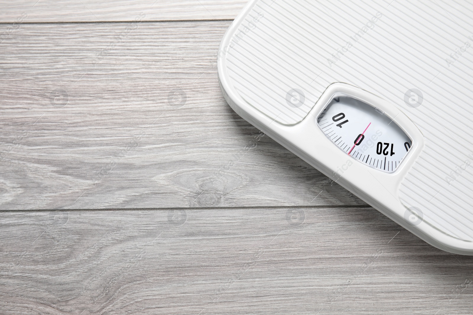 Photo of Scales on wooden background, top view with space for text. Weight loss