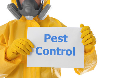 Photo of Man wearing protective suit holding sign PEST CONTROL on white background, closeup