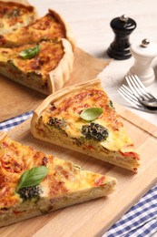 Photo of Delicious homemade vegetable quiche on wooden board