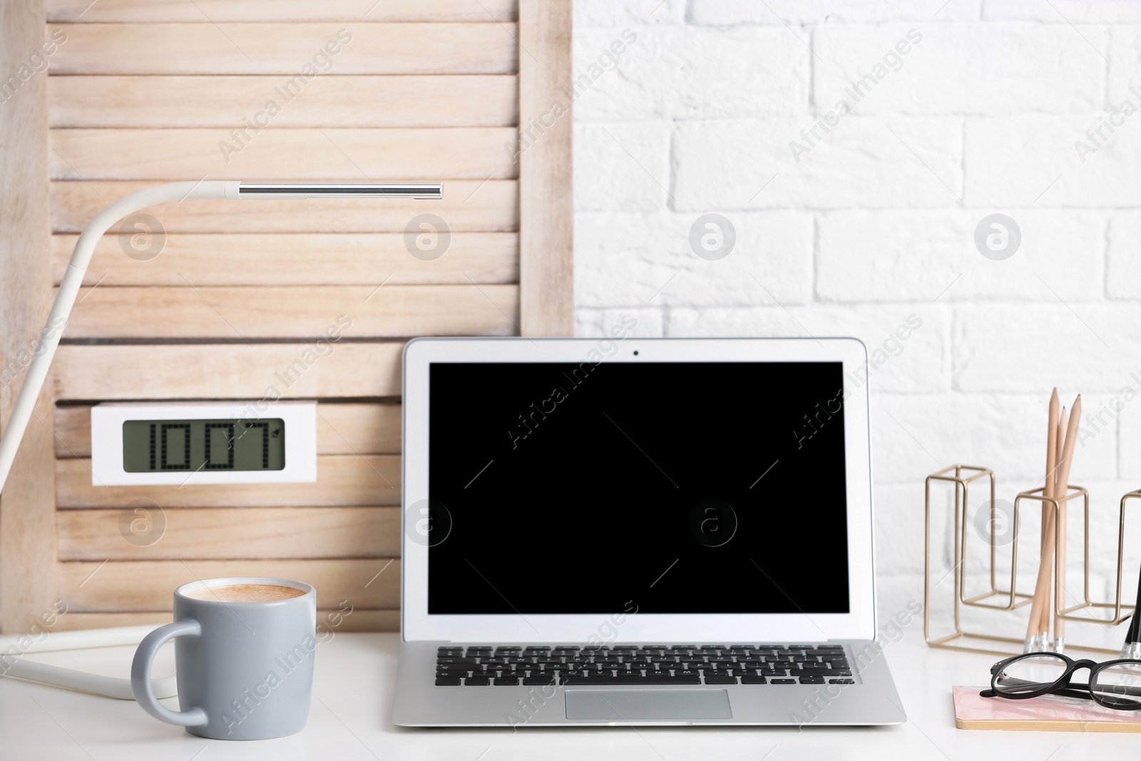 Photo of Coffee cup on table at modern workplace in office