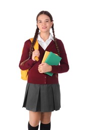 Photo of Teenage girl in school uniform with books and backpack on white background