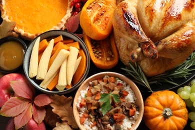 Photo of Traditional Thanksgiving day feast with delicious cooked turkey and other seasonal dishes as background, top view