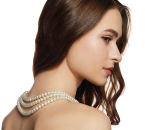 Young woman wearing elegant pearl necklace on white background