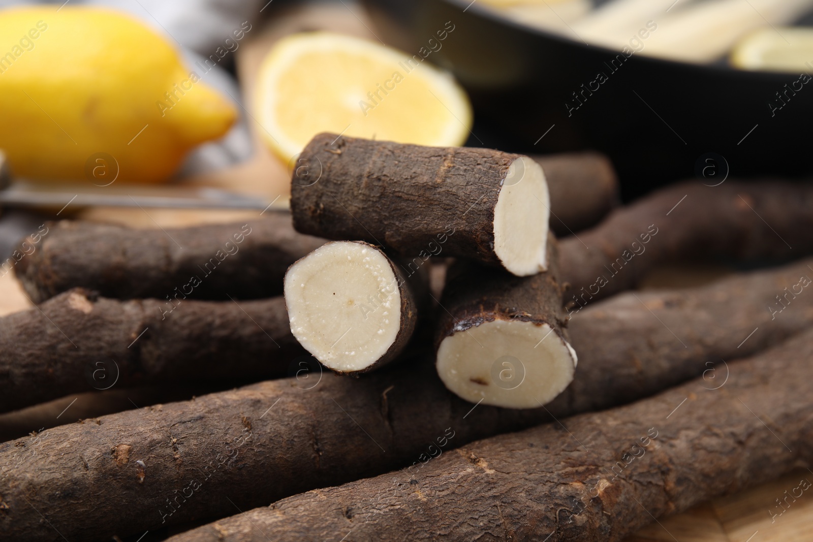 Photo of Fresh raw salsify roots on table, closeup