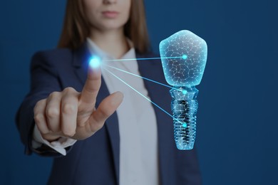 Image of Woman demonstrating virtual image of dental implant on blue background, closeup