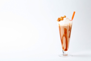 Glass with delicious milk shake on white background