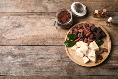 Photo of Flat lay composition with organic cocoa butter on wooden table. Space for text