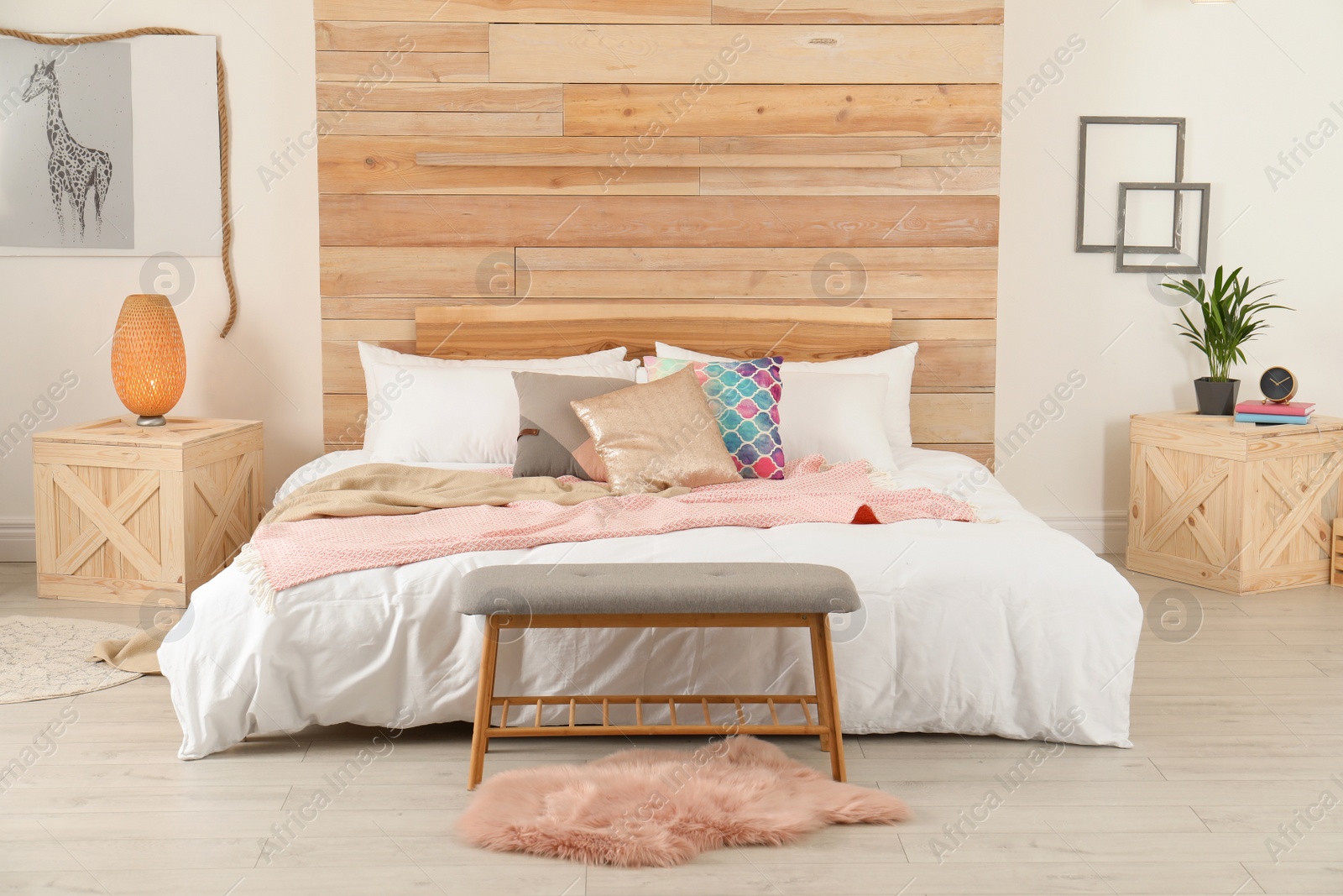 Photo of Stylish room interior with comfortable bed near wooden wall