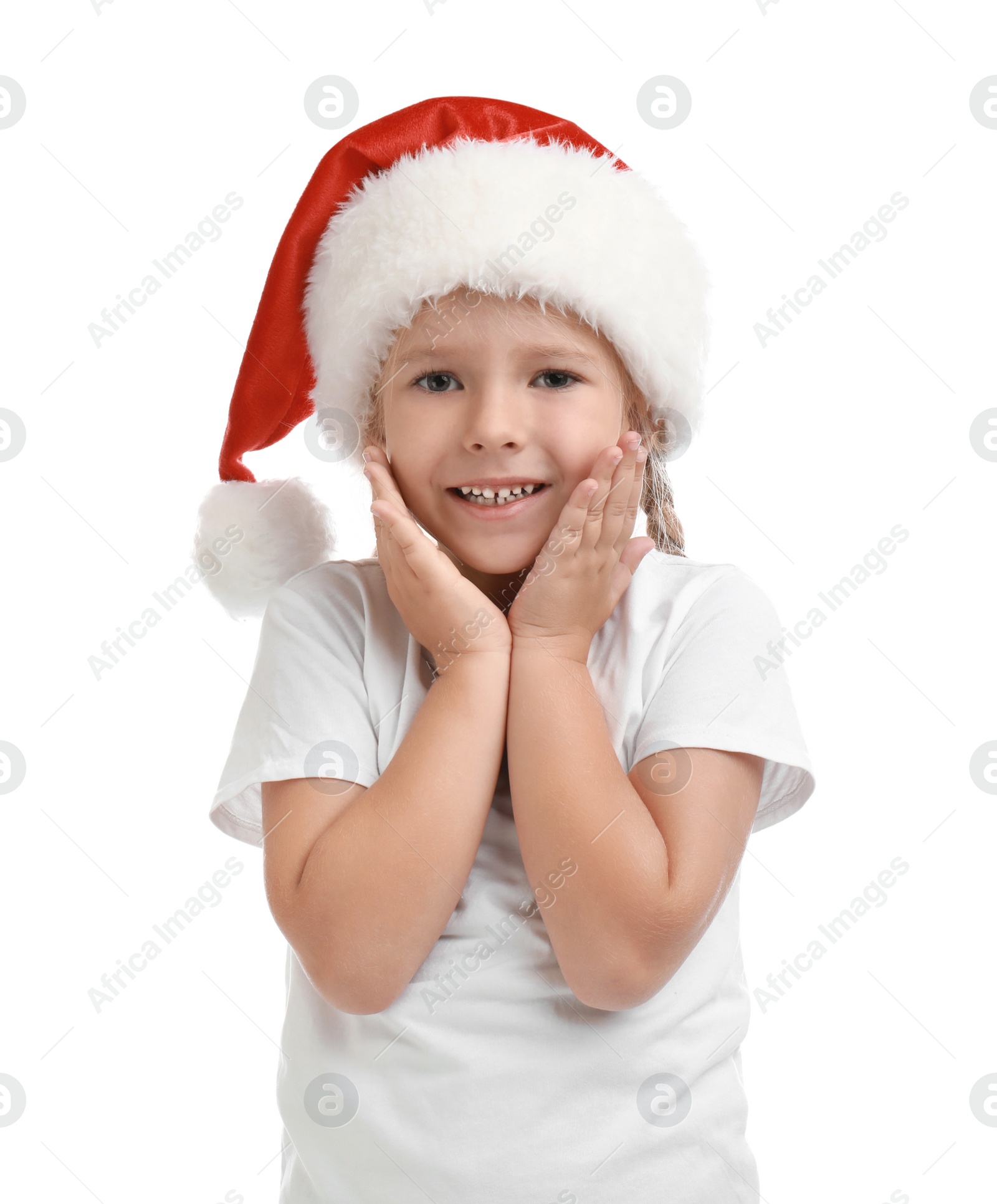 Photo of Cute little child wearing Santa hat on white background. Christmas holiday