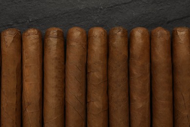 Photo of Many cigars on black table, flat lay