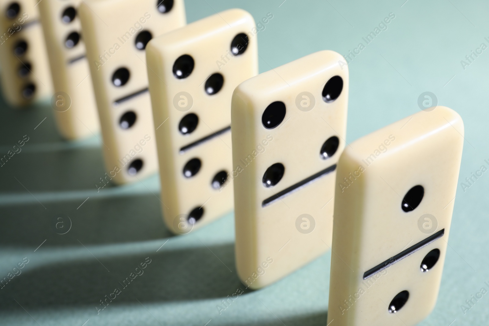 Photo of Classic domino tiles on grey background, closeup