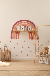 Child's room interior with rainbow painting on wall