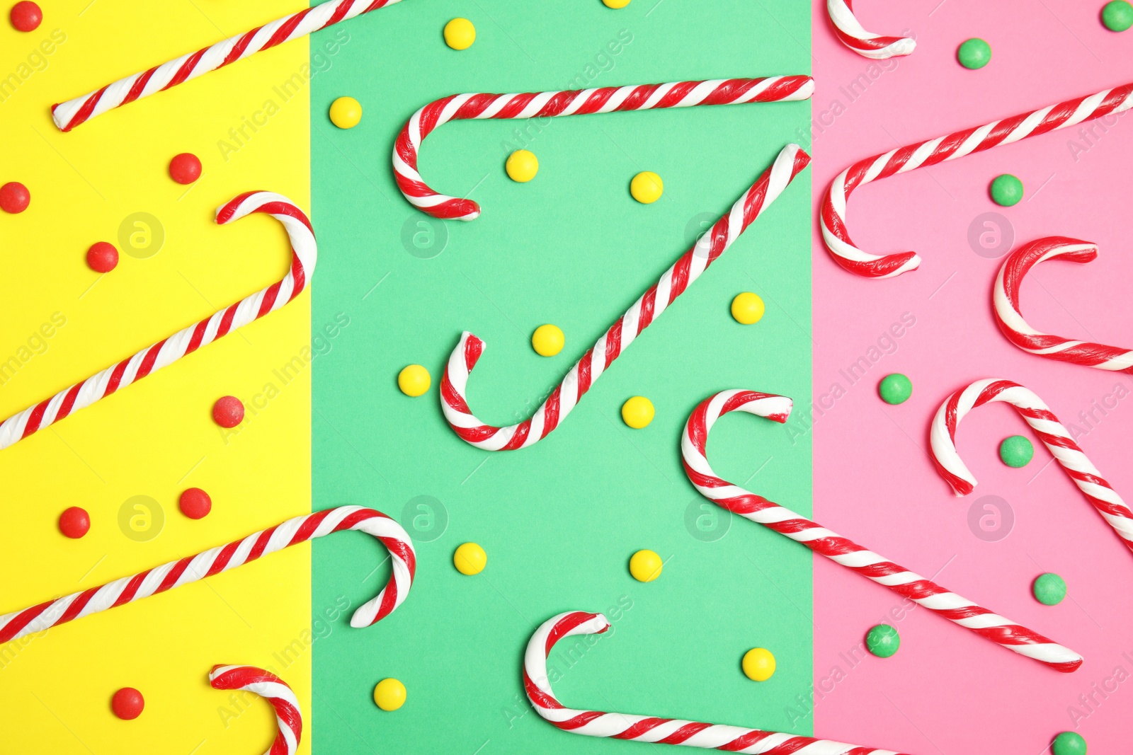 Photo of Flat lay composition with tasty candy canes on color background