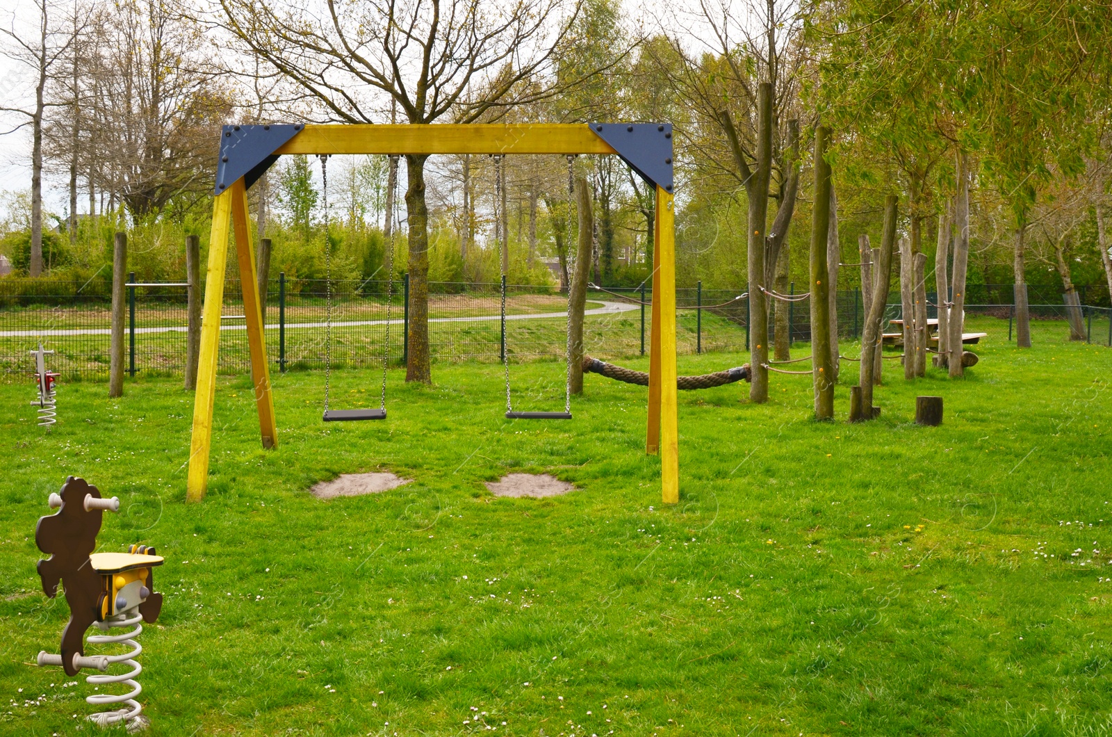 Photo of Beautiful park with playground for children. Outdoor recreation
