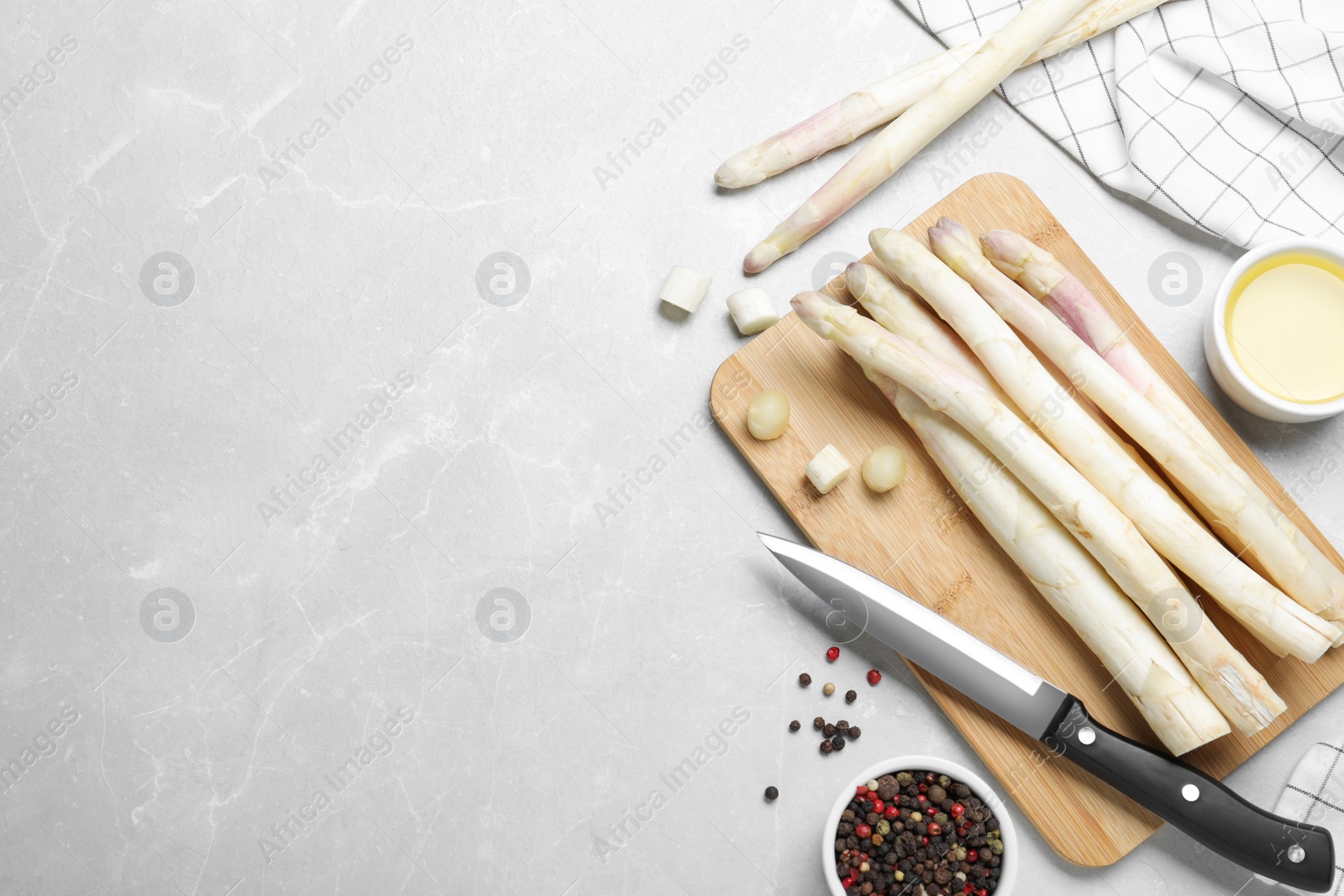 Photo of Flat lay composition with white asparagus on grey marble table. Space for text