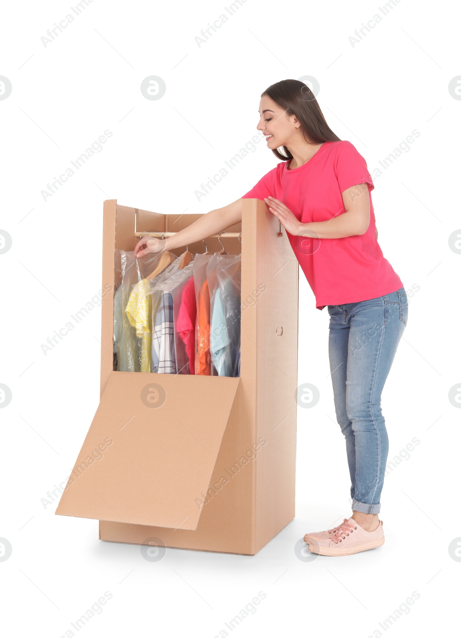 Photo of Young woman near wardrobe box on white background