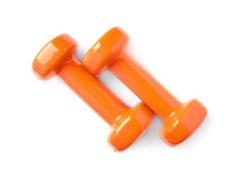 Photo of Color dumbbells on white background. Home fitness, top view